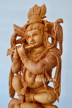 Baby Krishna sitting on snack fine wooden hand carved statue - Arts99 - Online Art Gallery